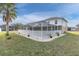 Back exterior of house with pool and screened patio at 4332 Lamson Ave, Spring Hill, FL 34608