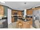 Modern kitchen with granite countertops, stainless steel appliances, and wood cabinets at 4332 Lamson Ave, Spring Hill, FL 34608