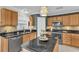Updated kitchen with wood cabinets, granite countertops and island at 4332 Lamson Ave, Spring Hill, FL 34608