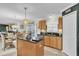 Bright kitchen with island, wood cabinets, and view to dining area at 4332 Lamson Ave, Spring Hill, FL 34608