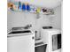 Laundry room with washer, dryer and shelving at 4332 Lamson Ave, Spring Hill, FL 34608