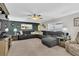 Relaxing living room with sectional sofa, accent pillows, and a ceiling fan at 4332 Lamson Ave, Spring Hill, FL 34608