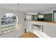 Open loft area with large window overlooking the street, chandelier, and a decorative sign at 4332 Lamson Ave, Spring Hill, FL 34608