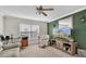 Home office features a large TV, desk, and comfortable seating at 4332 Lamson Ave, Spring Hill, FL 34608