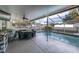Covered patio with pool, table, and grill at 4332 Lamson Ave, Spring Hill, FL 34608