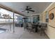 Covered patio with pool view, bar-height table, and ceiling fan at 4332 Lamson Ave, Spring Hill, FL 34608