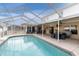 Enclosed patio area with refreshing pool at 4332 Lamson Ave, Spring Hill, FL 34608