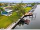 Waterfront property with dock, patio, and lush lawn at 4430 Floramar Ter, New Port Richey, FL 34652