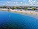 Aerial view of beach, homes and calm ocean water at 4430 Floramar Ter, New Port Richey, FL 34652