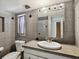 Bathroom with granite vanity and updated fixtures at 4430 Floramar Ter, New Port Richey, FL 34652