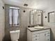Clean bathroom with granite vanity, updated mirror, and window at 4430 Floramar Ter, New Port Richey, FL 34652