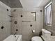 Updated bathroom with granite tile, shower, and bathtub at 4430 Floramar Ter, New Port Richey, FL 34652