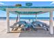 Beachfront picnic pavilion with gray tables and chairs at 4430 Floramar Ter, New Port Richey, FL 34652