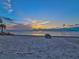 Peaceful beach sunset with palm trees and rocks at 4430 Floramar Ter, New Port Richey, FL 34652