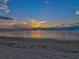 Peaceful beach sunset view with calm water and sandy shore at 4430 Floramar Ter, New Port Richey, FL 34652