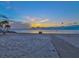 Serene beach sunset with palm trees and walkway at 4430 Floramar Ter, New Port Richey, FL 34652