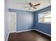 Bedroom with dark wood floors and blue walls at 4430 Floramar Ter, New Port Richey, FL 34652