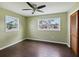Spacious bedroom with dark laminate flooring and ceiling fan at 4430 Floramar Ter, New Port Richey, FL 34652