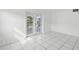 Versatile bonus room with white tile flooring and french doors at 4430 Floramar Ter, New Port Richey, FL 34652