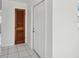 Bright entryway with white door and wood louvered door at 4430 Floramar Ter, New Port Richey, FL 34652