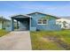 Newly renovated light blue house with carport and small front yard at 4430 Floramar Ter, New Port Richey, FL 34652