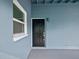 Black front door with white trim at 4430 Floramar Ter, New Port Richey, FL 34652