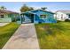 Cute teal house with a driveway, and well-maintained lawn at 4430 Floramar Ter, New Port Richey, FL 34652