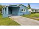 Newly renovated teal house with carport and landscaping at 4430 Floramar Ter, New Port Richey, FL 34652