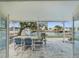 Covered patio with table and chairs, overlooking the canal at 4430 Floramar Ter, New Port Richey, FL 34652