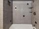 Bathroom shower with granite tile, built-in shelves, and a modern faucet at 4430 Floramar Ter, New Port Richey, FL 34652