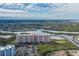 Aerial view of a waterfront condo building with parking and boat docks at 4516 Seagull Dr # 417, New Port Richey, FL 34652