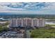 Aerial view of a waterfront condo building with parking and lush landscaping at 4516 Seagull Dr # 417, New Port Richey, FL 34652