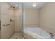 Bathroom with corner bathtub and a separate shower stall at 4516 Seagull Dr # 417, New Port Richey, FL 34652