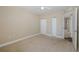 Bedroom with carpeted floor, ceiling fan, and double door closet at 4516 Seagull Dr # 417, New Port Richey, FL 34652