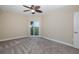 Bedroom with ceiling fan and carpeting, plus balcony access at 4516 Seagull Dr # 417, New Port Richey, FL 34652