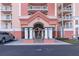 Condo building entrance with columns, fountain, and a covered walkway at 4516 Seagull Dr # 417, New Port Richey, FL 34652