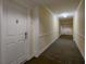 Clean and well-lit condo hallway with carpeted floor at 4516 Seagull Dr # 417, New Port Richey, FL 34652