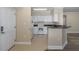 Condo kitchen with white cabinets, and modern appliances at 4516 Seagull Dr # 417, New Port Richey, FL 34652