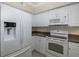 Condo kitchen with white appliances and granite countertops at 4516 Seagull Dr # 417, New Port Richey, FL 34652