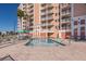 Community pool with surrounding lounge chairs at 4516 Seagull Dr # 417, New Port Richey, FL 34652
