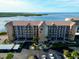 Aerial view of waterfront condo building with parking at 4620 Bay Blvd # 1158, Port Richey, FL 34668