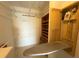 Well-equipped laundry room with built-in ironing board and shelving at 4620 Bay Blvd # 1158, Port Richey, FL 34668