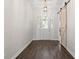 Bright entryway featuring a sliding barn door, hardwood floors, and decorative glass front door at 4801 Majestic Hills Loop, Brooksville, FL 34601