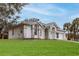 Single story home with a 2 car garage and lush green lawn at 5083 Carnation Ct, Spring Hill, FL 34607