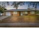 Ranch-style home with single-car garage at dusk at 5121 Bromley Ave, Spring Hill, FL 34609