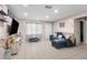 Living room with tile floors, sectional sofa, and large TV at 5121 Bromley Ave, Spring Hill, FL 34609