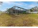 Spacious backyard featuring a screened-in pool and generous green space at 5286 Hamlet Cir, Spring Hill, FL 34606