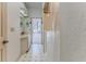 Bathroom with a vanity sink, shower with curtain, and a door leading to the pool area at 5286 Hamlet Cir, Spring Hill, FL 34606