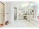 Expansive bathroom features a tiled floor, double vanity, walk-in shower, and a bright window seat at 5286 Hamlet Cir, Spring Hill, FL 34606