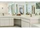 Bathroom vanity with double sinks, mirrors, and ample cabinet storage at 5286 Hamlet Cir, Spring Hill, FL 34606